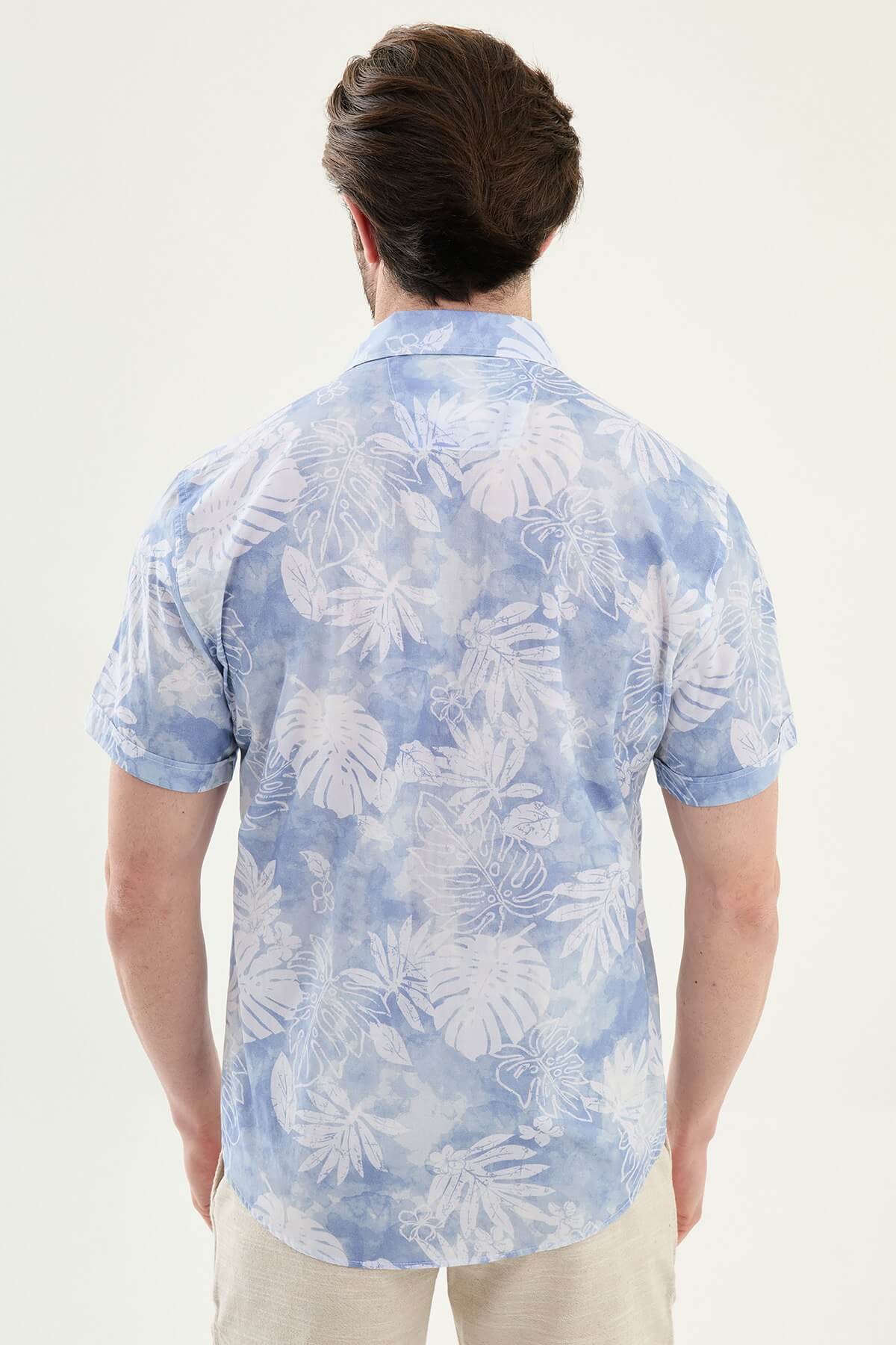 Men’s blue tropical print short sleeve shirt crafted from lightweight 100% cotton, designed for relaxed summer and resort wear styling.