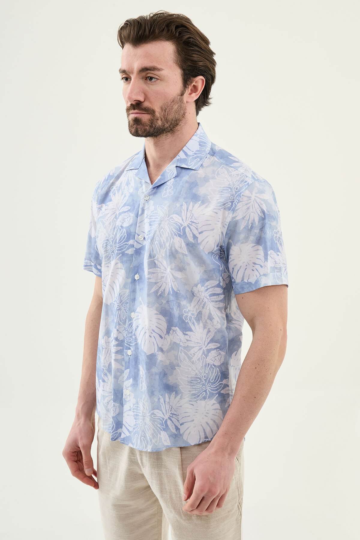 Men’s blue tropical print short sleeve shirt crafted from lightweight 100% cotton, designed for relaxed summer and resort wear styling.