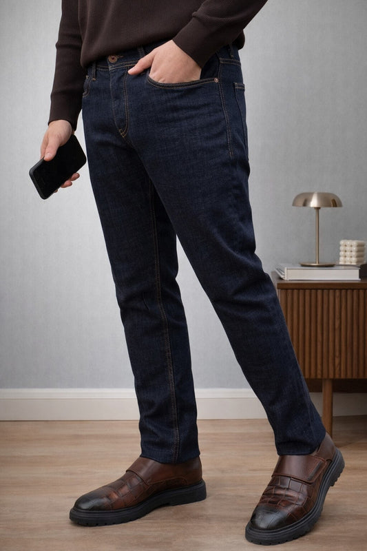 slim-fit blue jeans paired with a casual top, standing outdoors, highlighting the fit and classic blue color