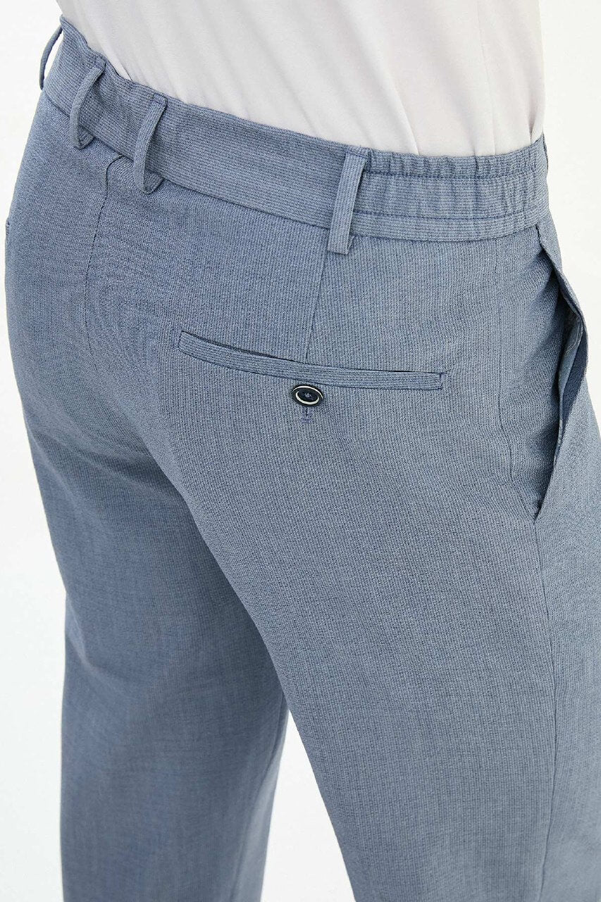 Man wearing blue slim-fit summer trousers