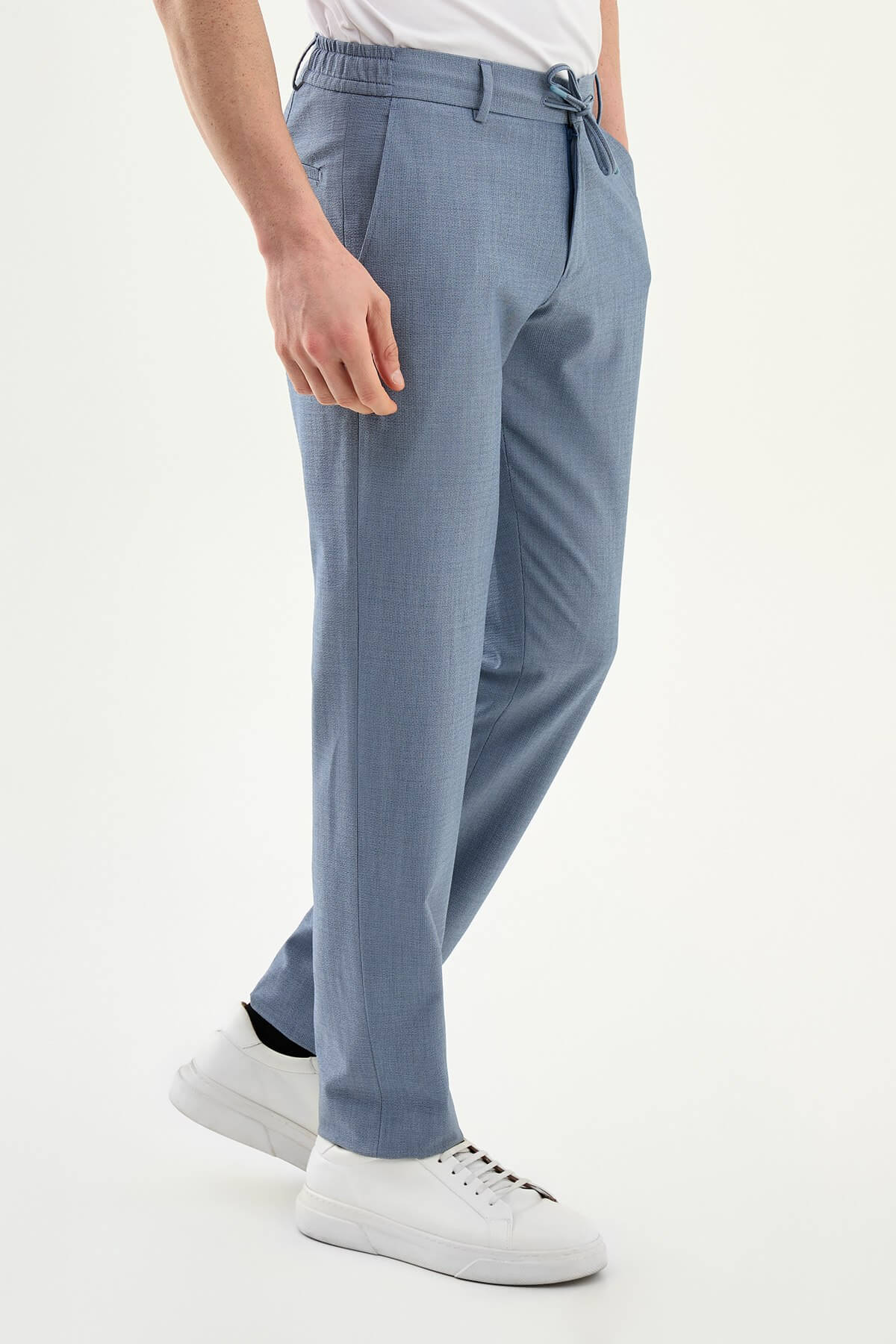 Man wearing blue slim-fit summer trousers