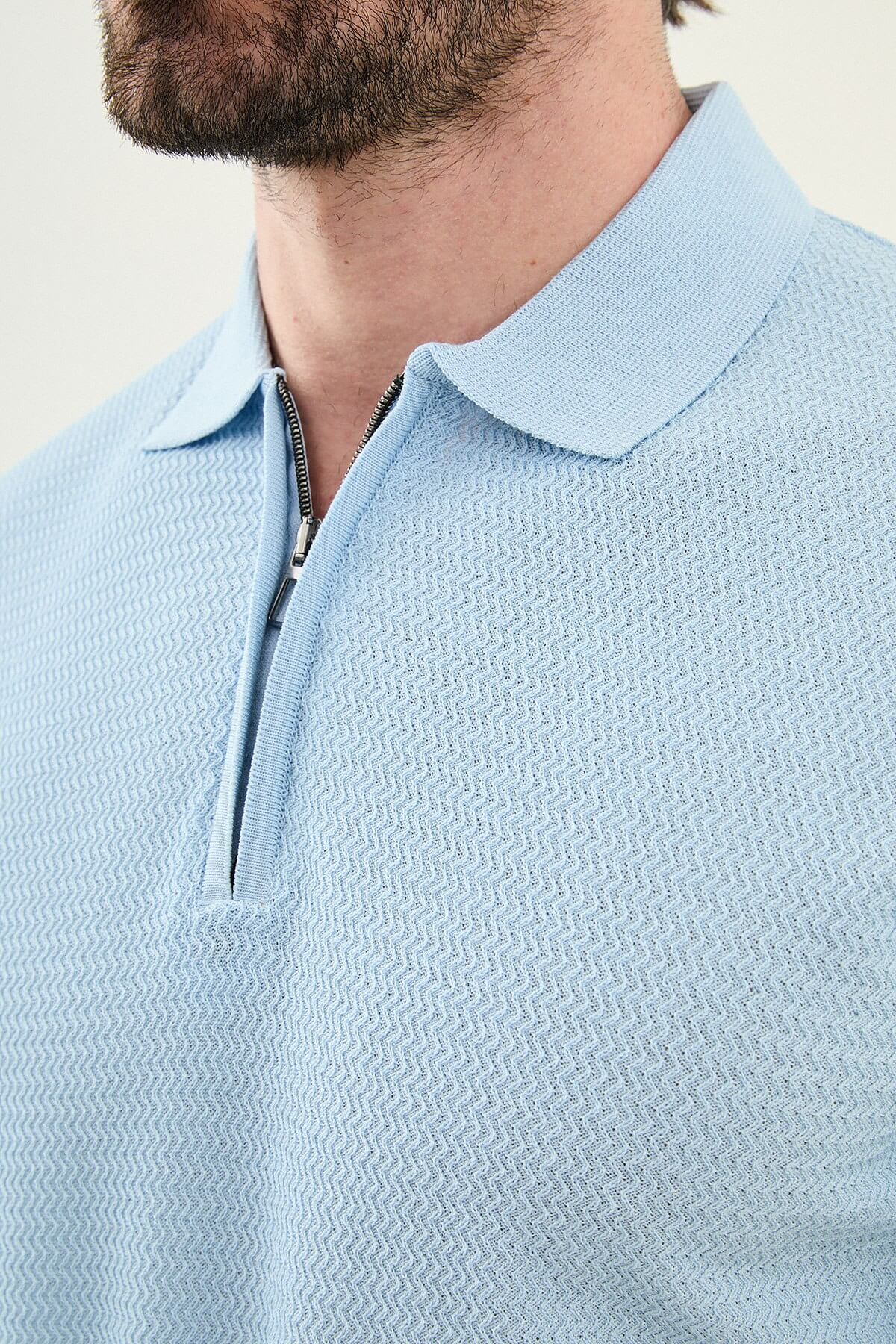 Man wearing a blue slim-fit quarter-zip polo T-shirt, short sleeves, standing against a neutral background, styled for summer casual wear.