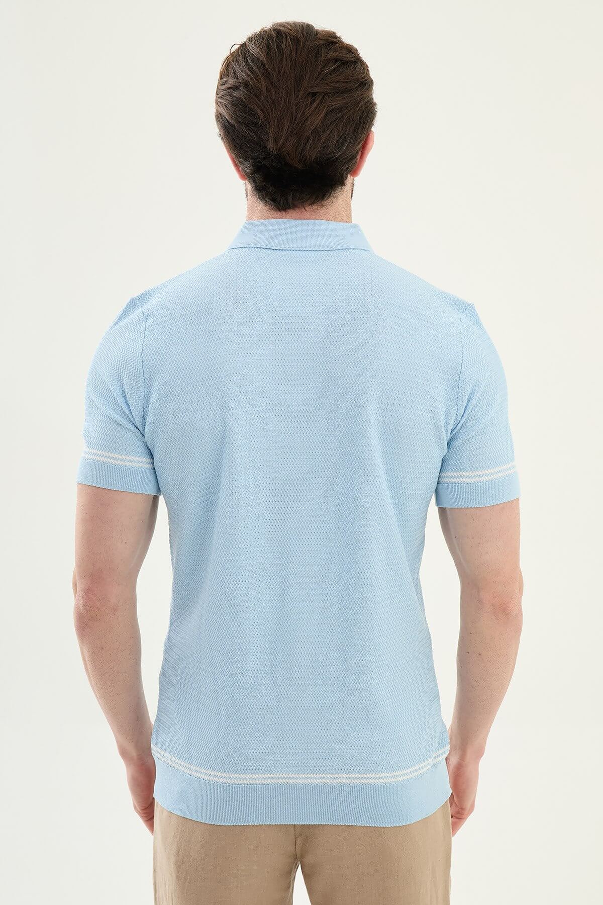 Man wearing a blue slim-fit quarter-zip polo T-shirt, short sleeves, standing against a neutral background, styled for summer casual wear.