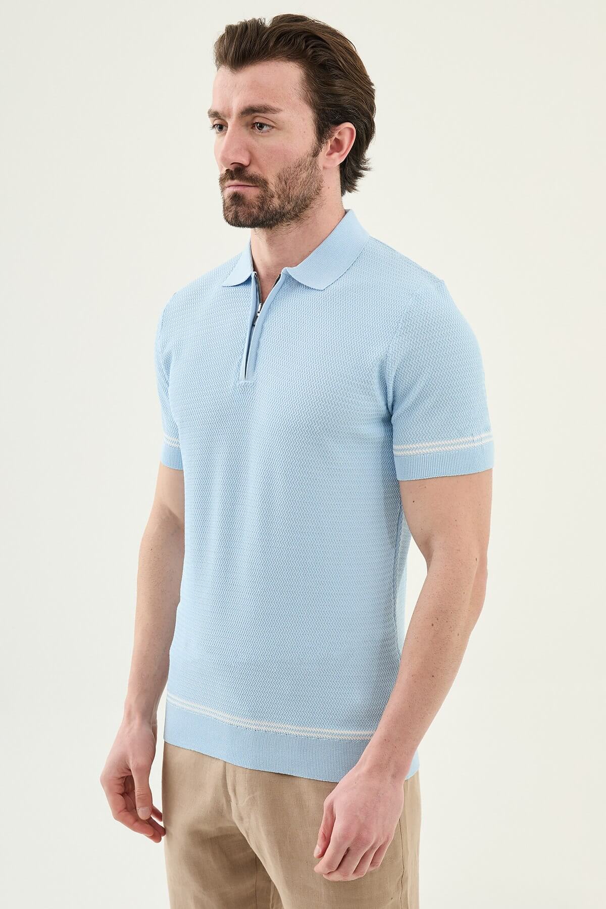 Man wearing a blue slim-fit quarter-zip polo T-shirt, short sleeves, standing against a neutral background, styled for summer casual wear.
