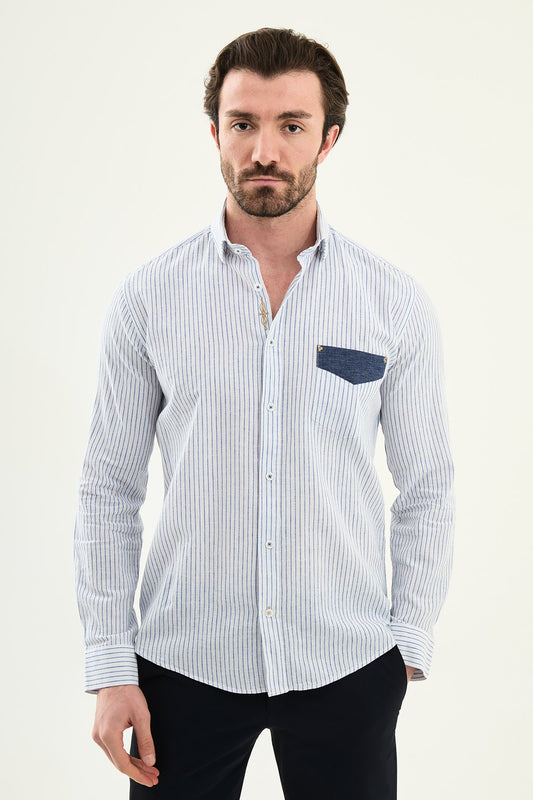 blue slim-fit long sleeve shirt with a contrasting pocket detail, standing indoors against a neutral backdrop