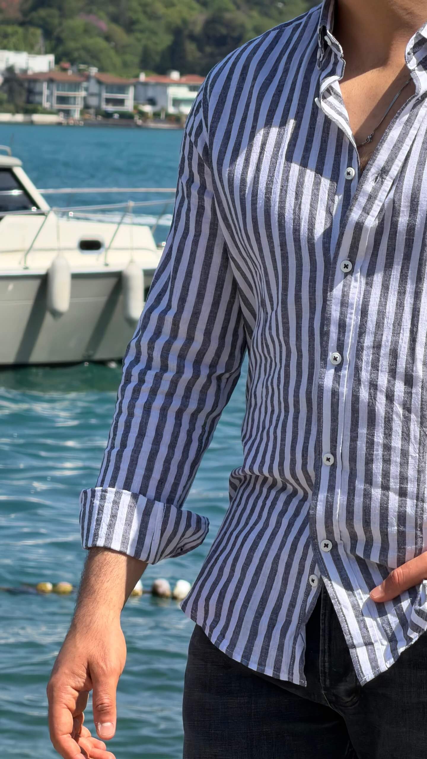 Blue and white striped linen shirt with button front, side view