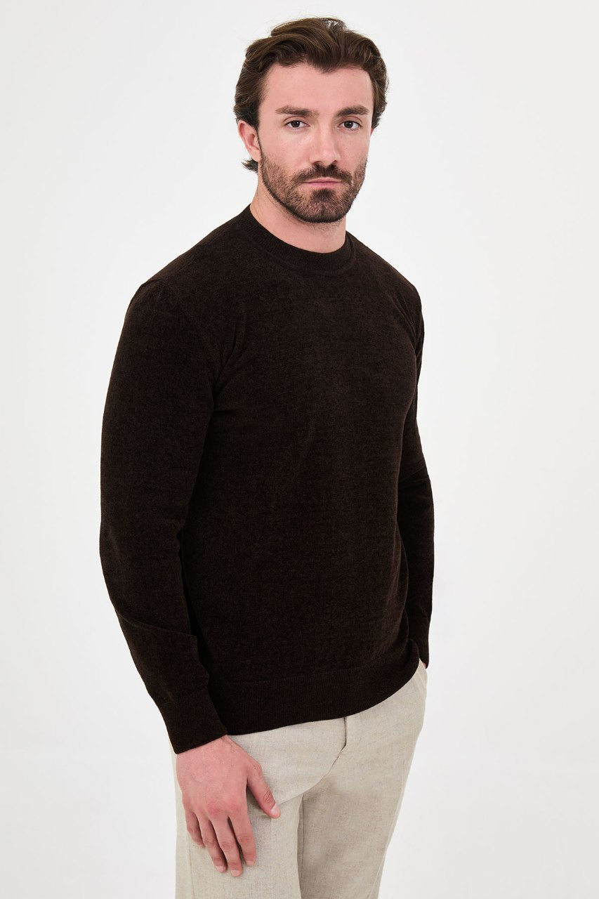Men’s brown crew neck knit sweater in a cotton blend slim fit design styled with beige trousers for a refined fall winter outfit.