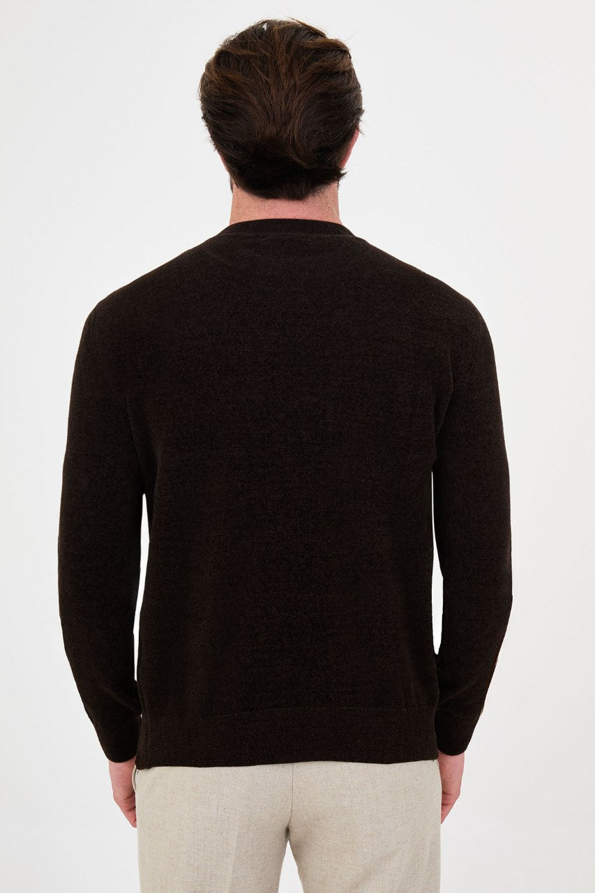Men’s brown crew neck knit sweater in a cotton blend slim fit design styled with beige trousers for a refined fall winter outfit.