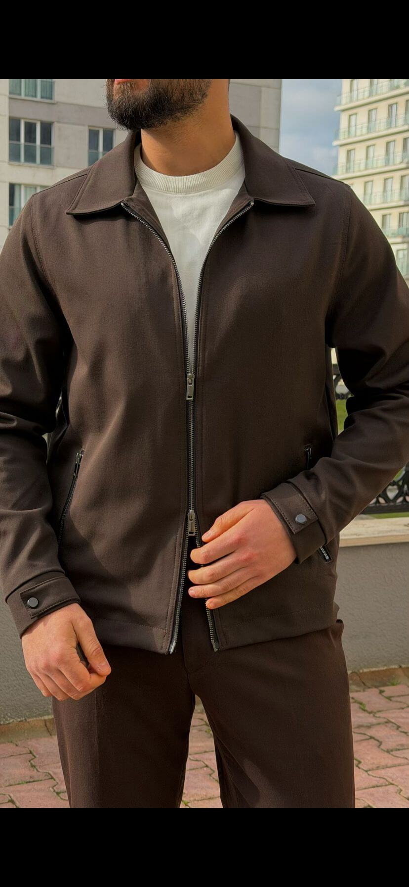 Men’s brown zip-up jacket with tailored fit and minimalist design, smart casual outerwear styled with matching trousers