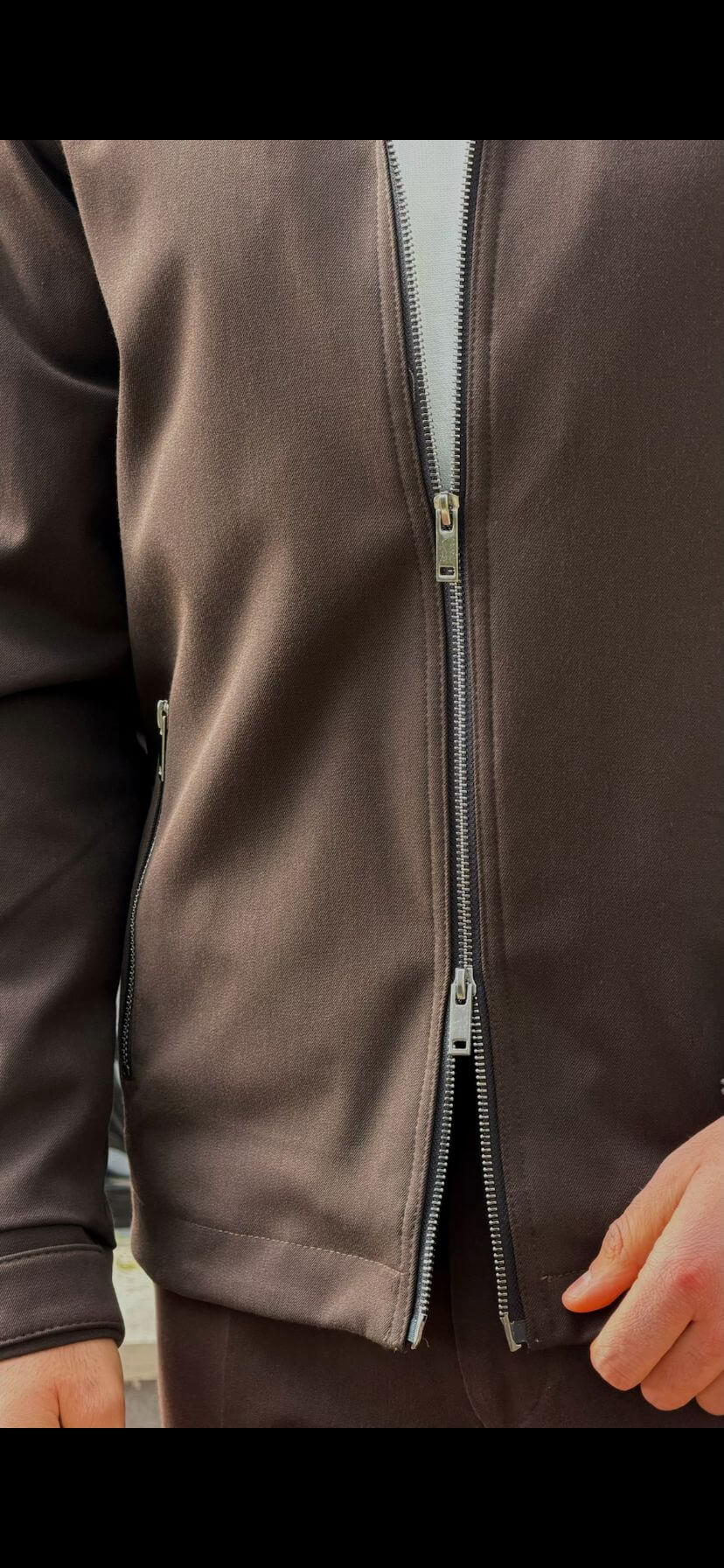 Men’s brown zip-up jacket with tailored fit and minimalist design, smart casual outerwear styled with matching trousers
