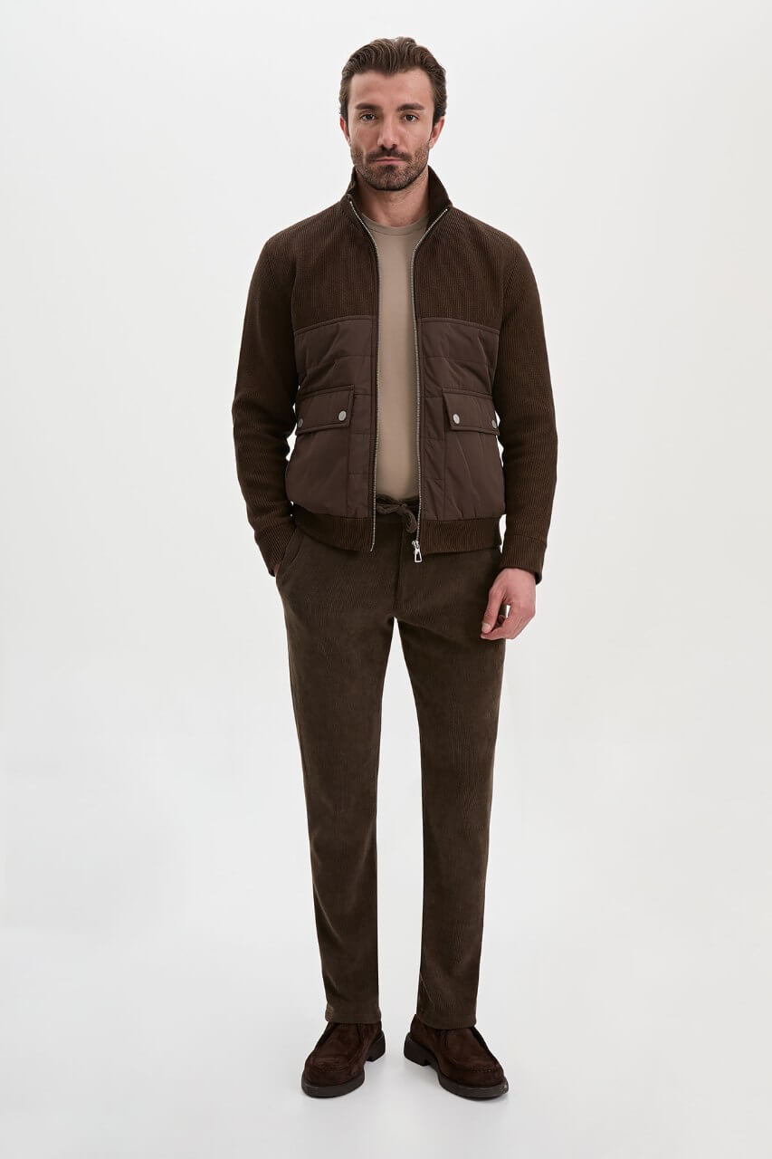 Brown men's casual jacket styled with a neutral top and dark trousers.