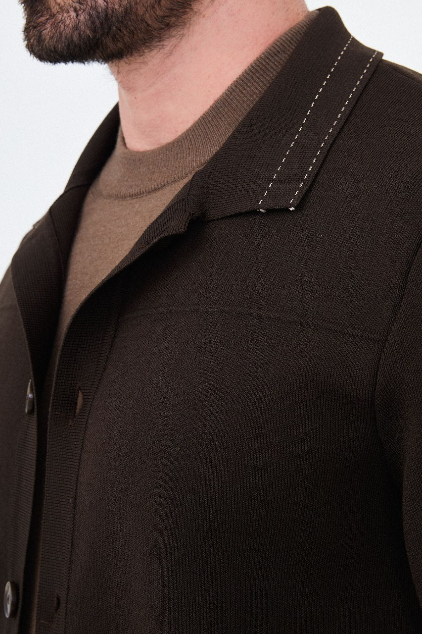 Men’s brown cotton blend knit button-up cardigan styled with trousers for fall winter fashion