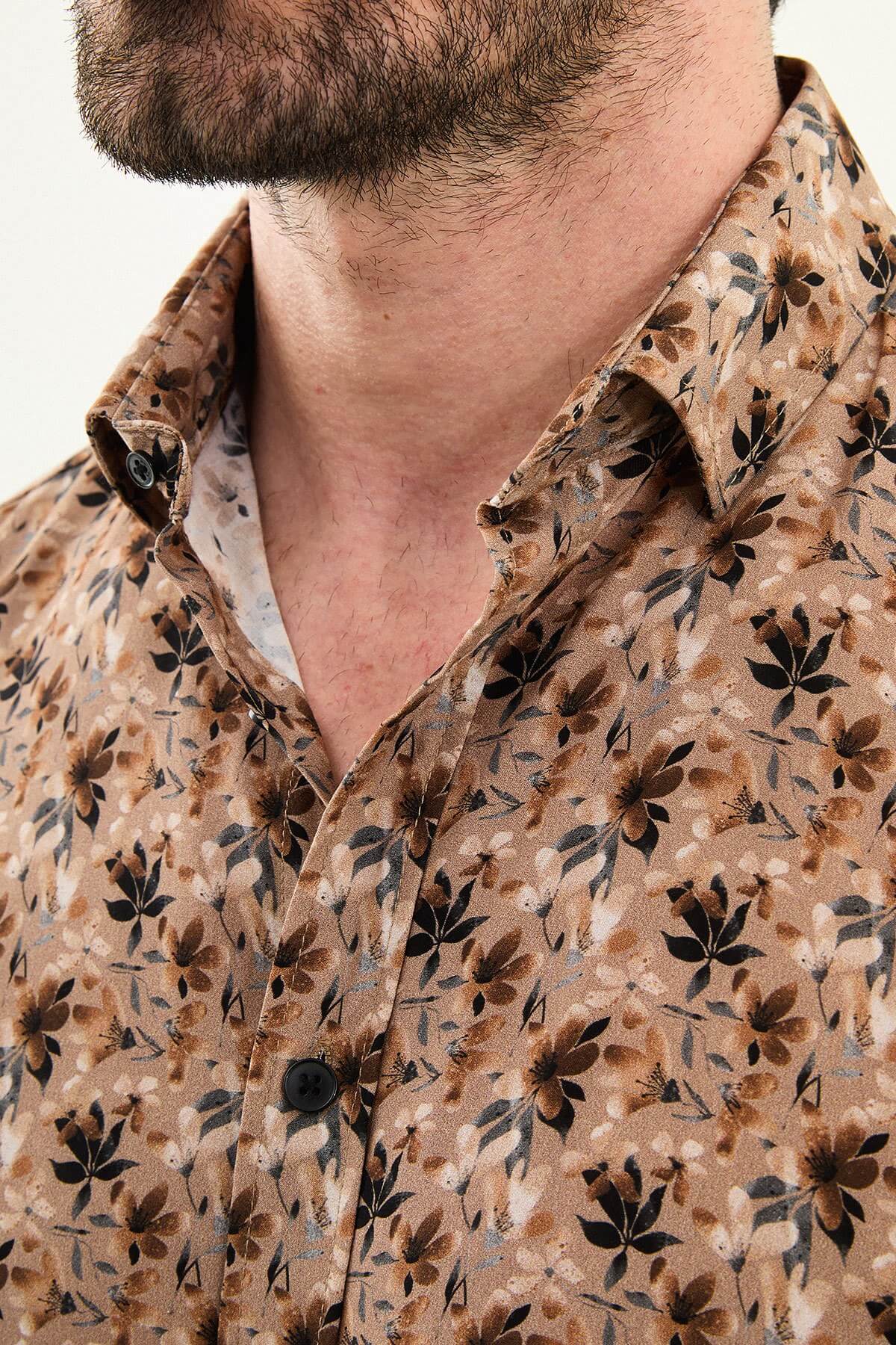 Brown slim-fit long-sleeve men’s shirt with all-over subtle pattern, structured collar, and buttoned cuffs.