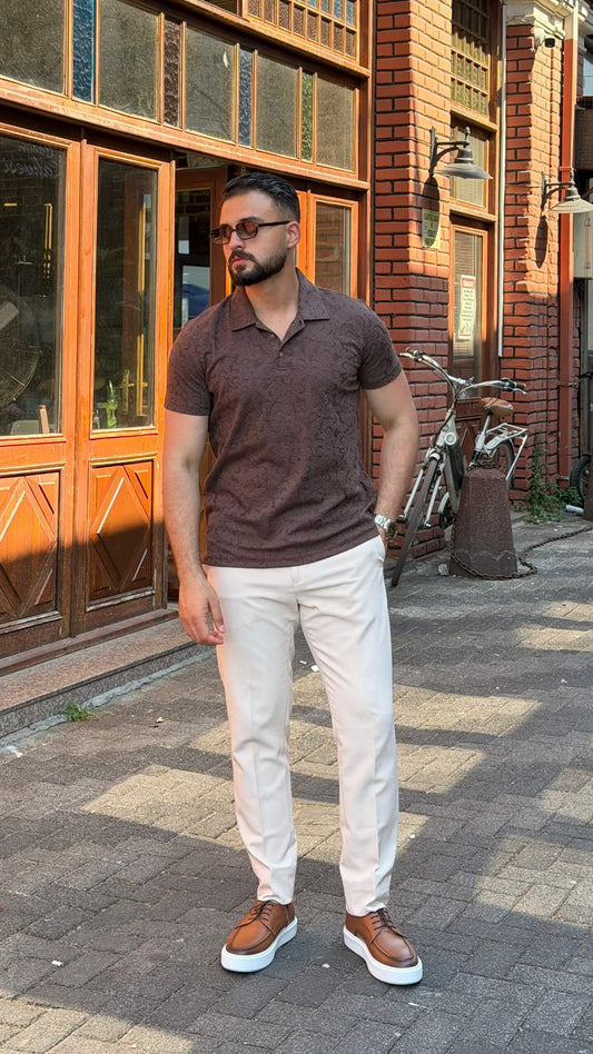 Men's brown paisley jacquard polo shirt styled with white trousers