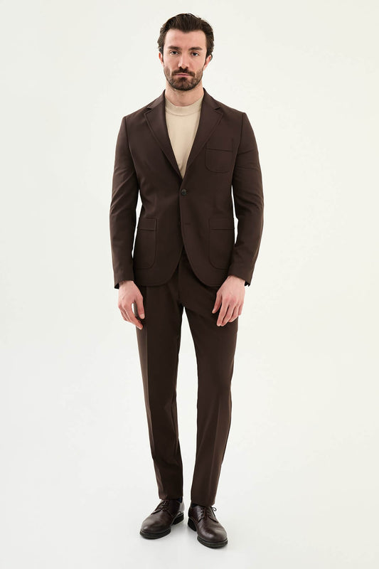 Men’s brown slim fit blazer with a clean modern design and stretch fabric, styled with a beige knit top for elegant smart casual and evening looks.