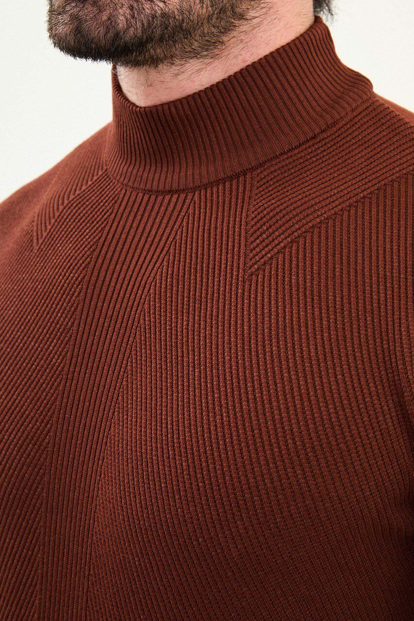 Men’s tile (terracotta) slim-fit ribbed mock-neck cotton-blend sweater with multi-directional ribbing and diagonal chest panels, styled with blue denim.