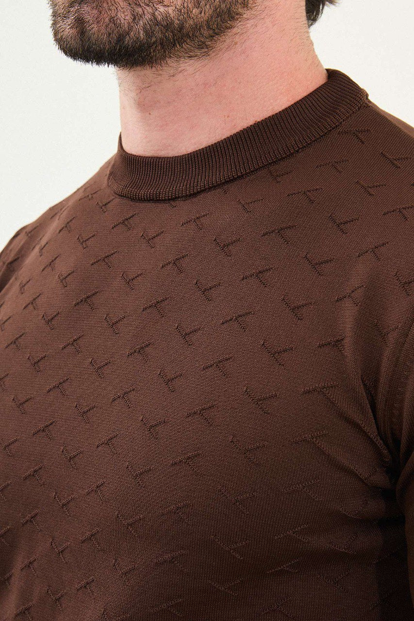Men’s slim-fit chocolate brown crew-neck sweater with geometric ‘T’ textured knit front panel, cotton-viscose-elastane blend, styled with cream trousers.
