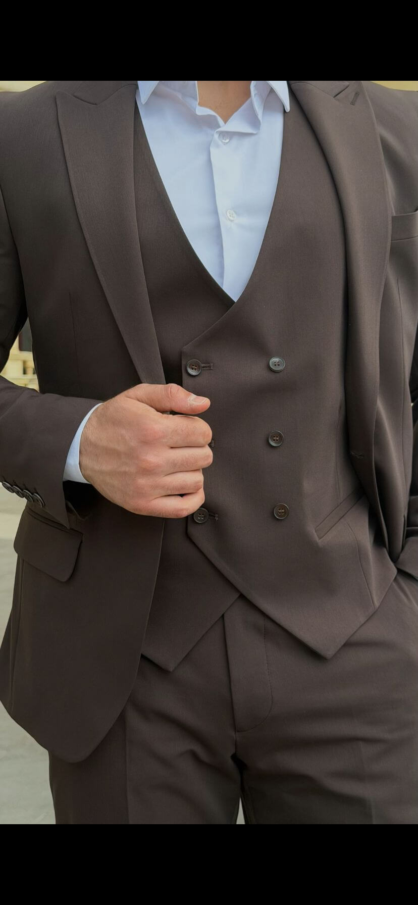 Men wearing a brown shawl lapel slim-fit suit with matching vest and trousers, styled formally for outdoor wedding or business event