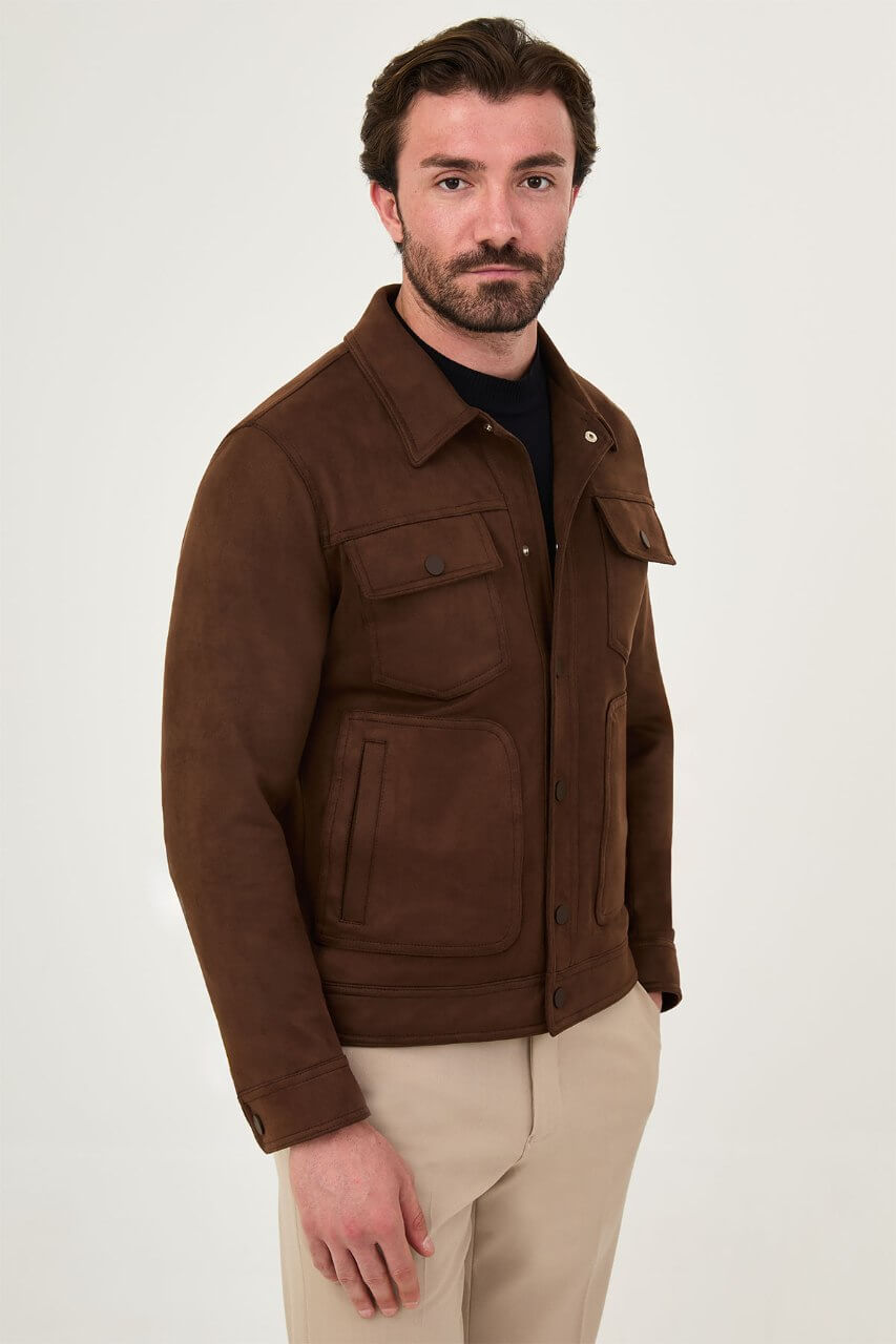 Men's brown suede-style jacket paired with a black sweater and beige trousers.