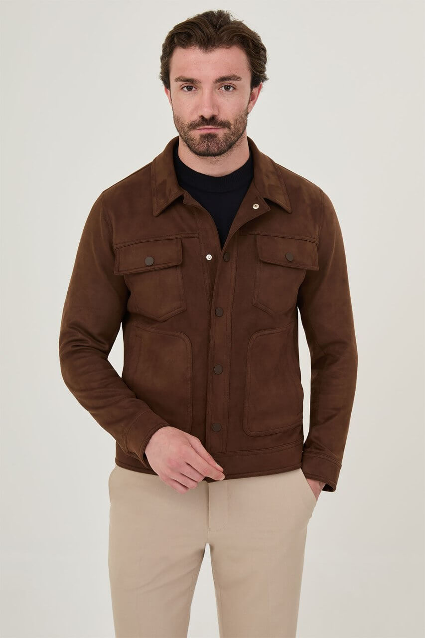 Men's brown suede-style jacket paired with a black sweater and beige trousers.