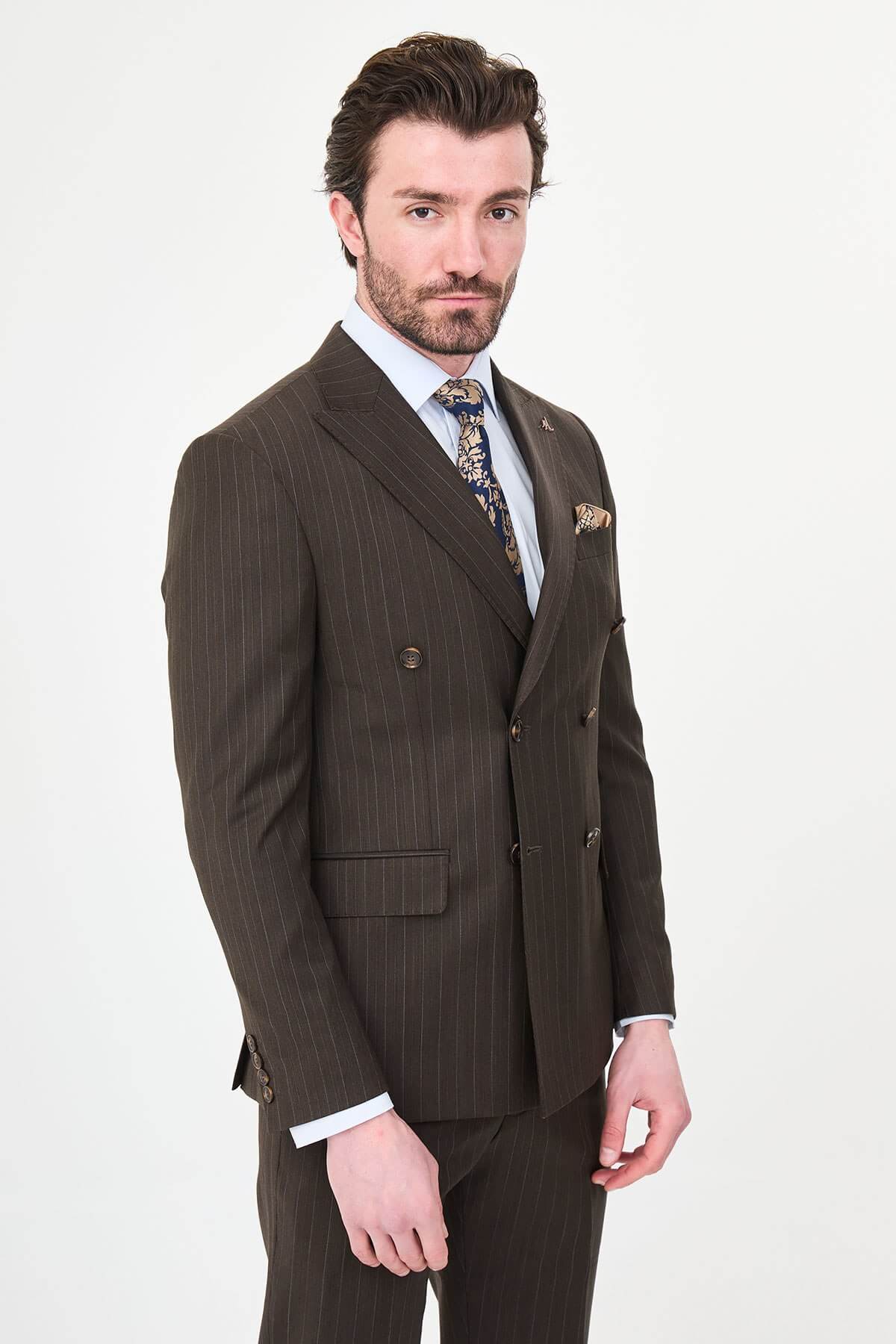 man dressed in a brown double-breasted premium wool suit with matching trousers and brown shoes