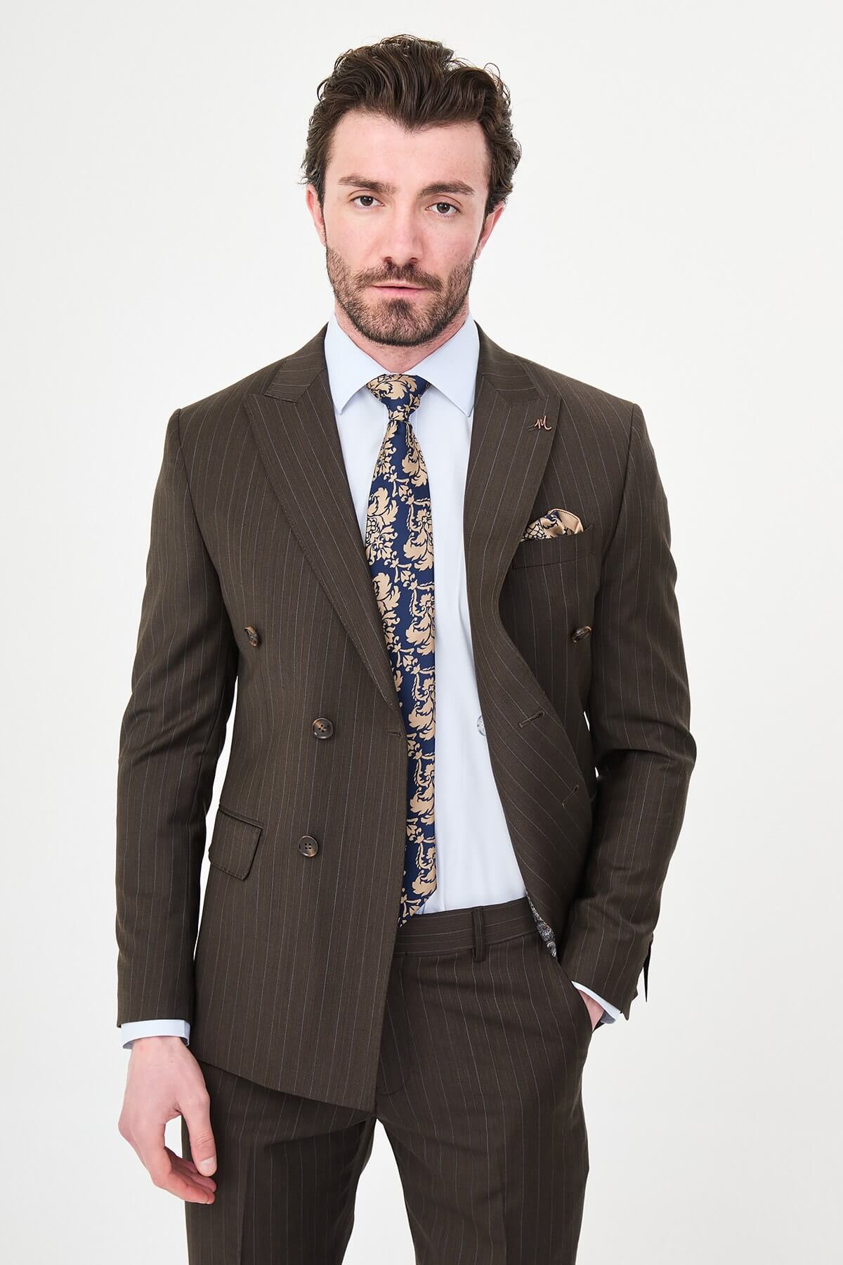 man dressed in a brown double-breasted premium wool suit with matching trousers and brown shoes