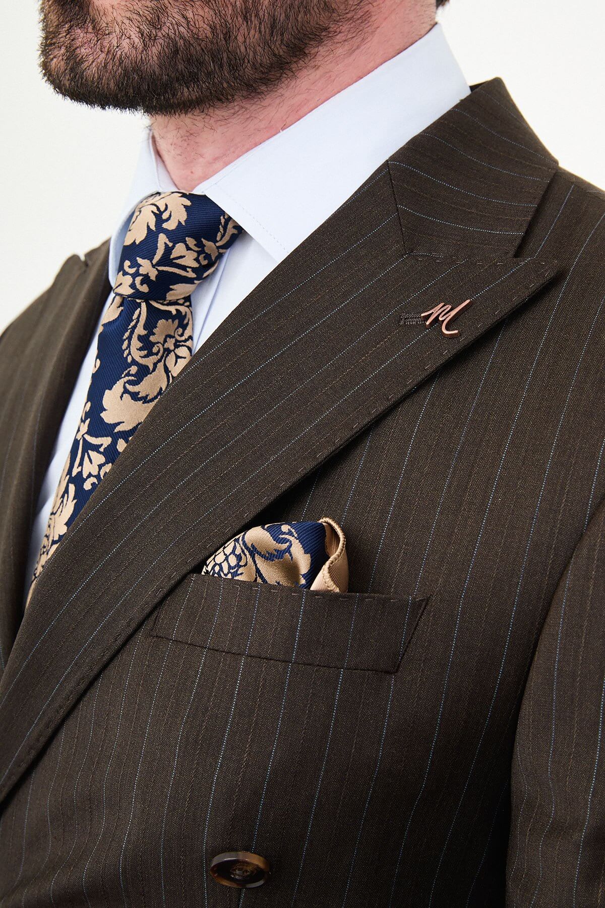man dressed in a brown double-breasted premium wool suit with matching trousers and brown shoes