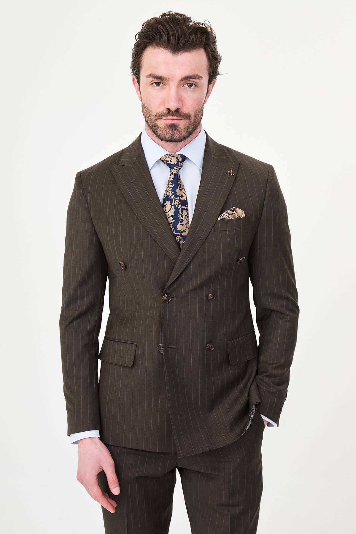 man dressed in a brown double-breasted premium wool suit with matching trousers and brown shoes