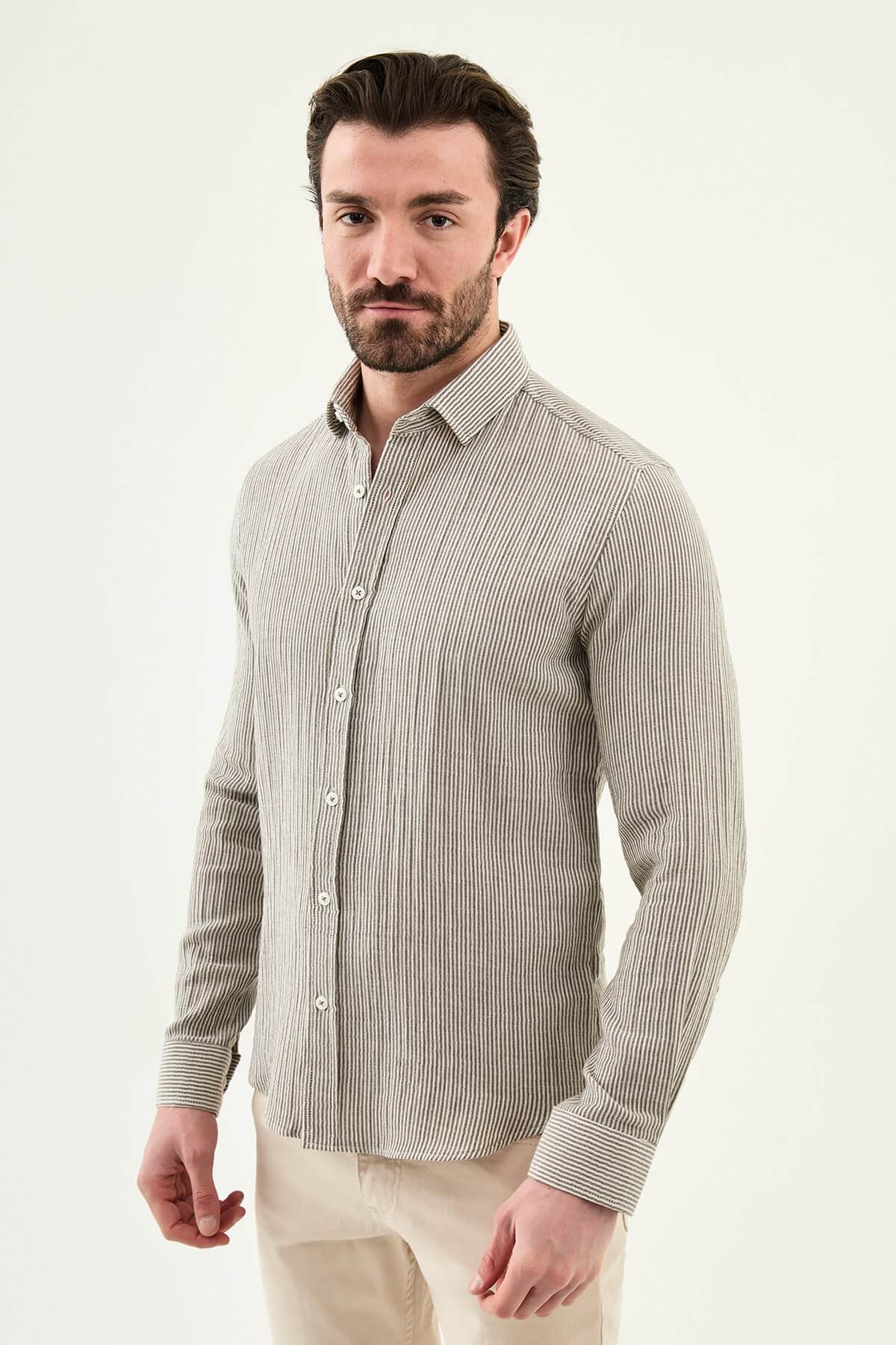 Men wearing a brown slim-fit long sleeve cotton shirt with a chest pocket, standing casually, showcasing the tailored fit and fabric texture.