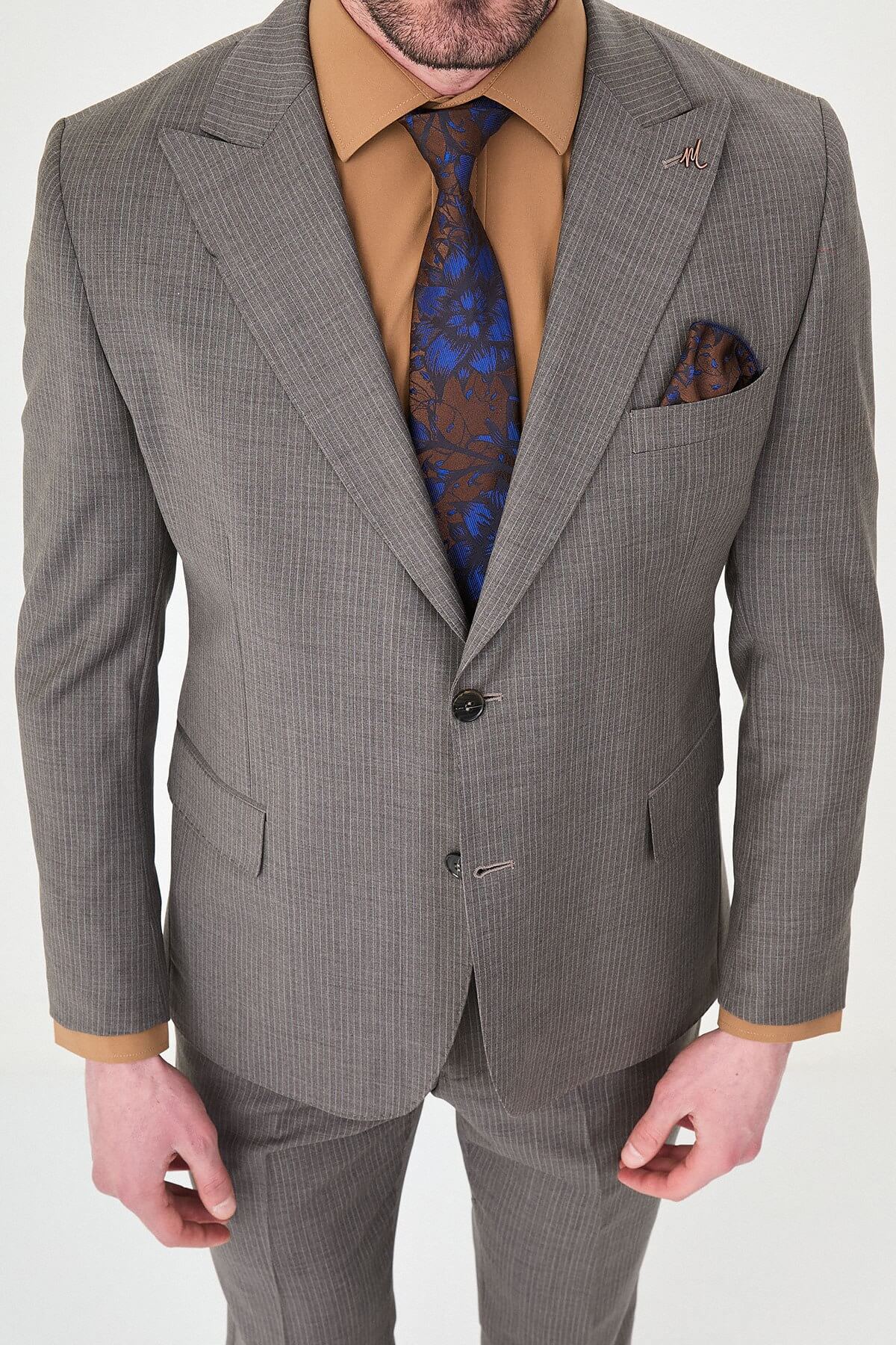 man in a Brown Slim Fit Wide Collar Premium Wool Suit, highlighting the slim-fit trousers and polished dress shoes.