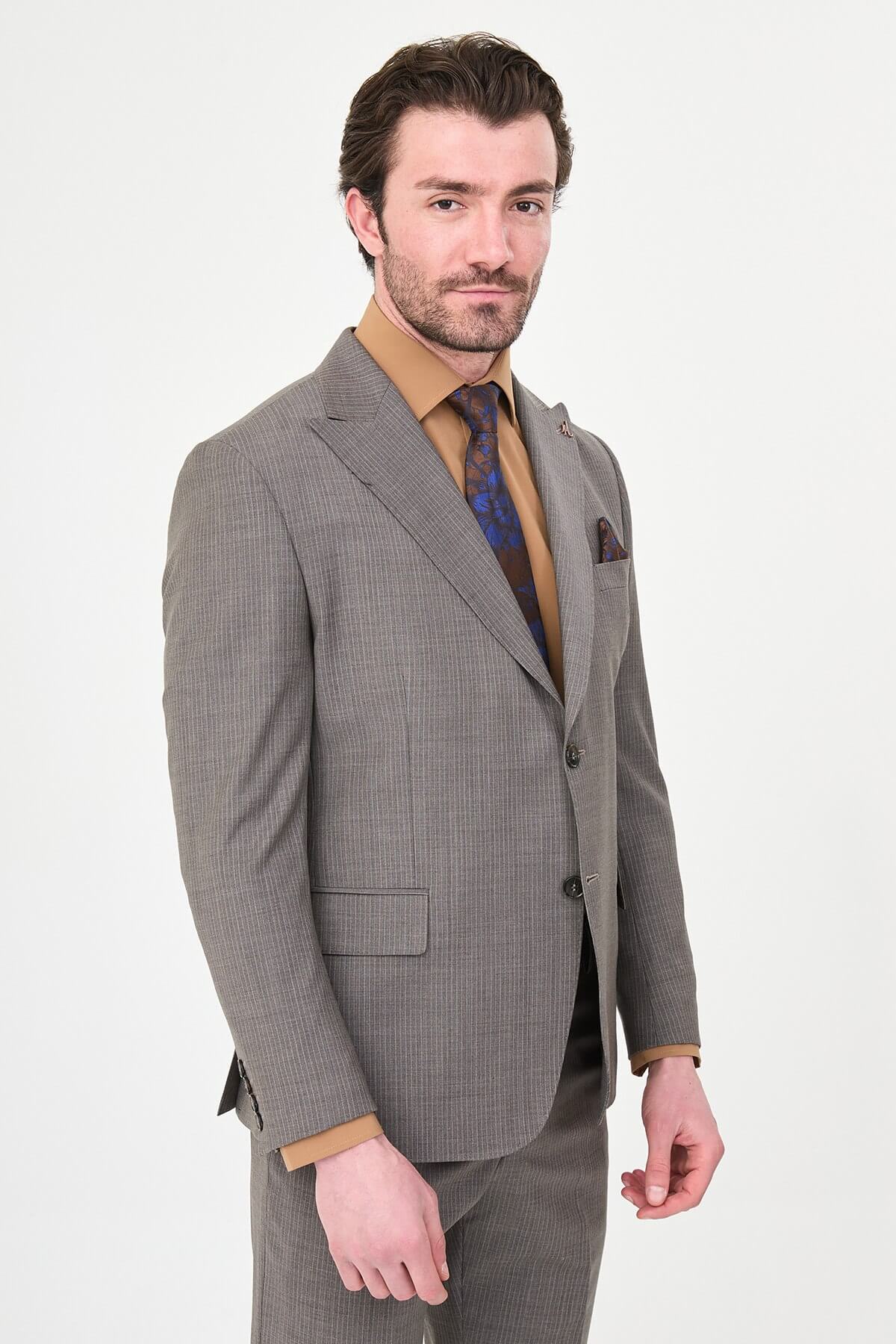 man in a Brown Slim Fit Wide Collar Premium Wool Suit, highlighting the slim-fit trousers and polished dress shoes.