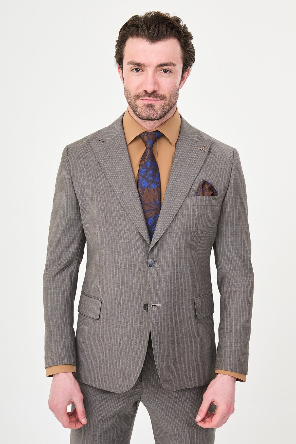man in a Brown Slim Fit Wide Collar Premium Wool Suit, highlighting the slim-fit trousers and polished dress shoes.