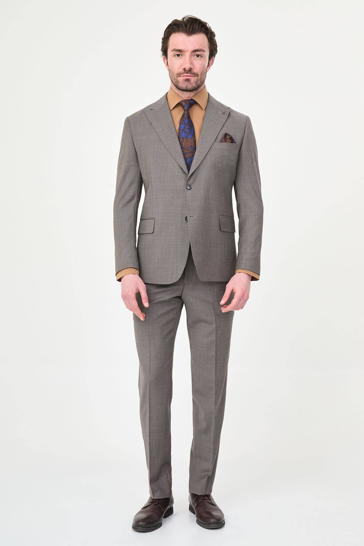 man in a Brown Slim Fit Wide Collar Premium Wool Suit, highlighting the slim-fit trousers and polished dress shoes.