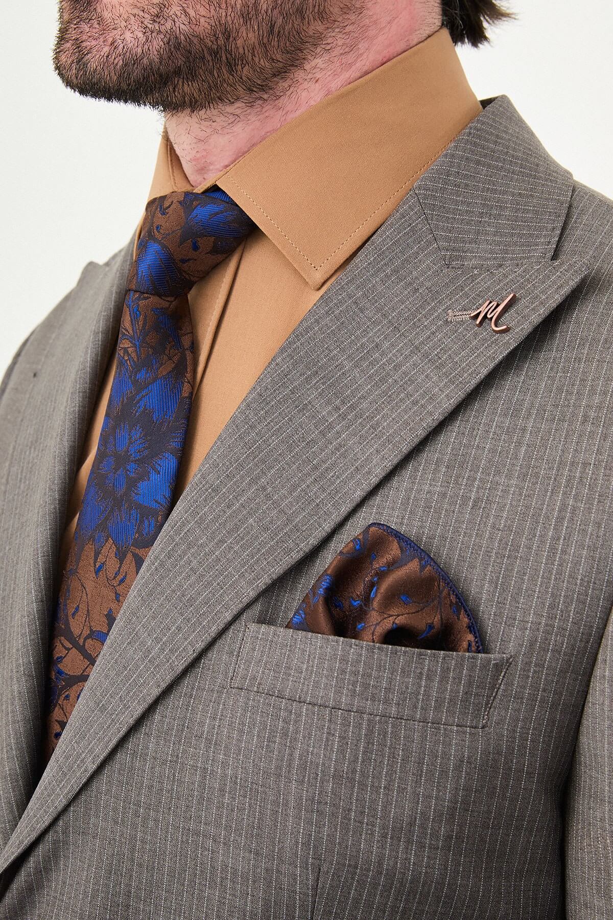 man in a Brown Slim Fit Wide Collar Premium Wool Suit, highlighting the slim-fit trousers and polished dress shoes.