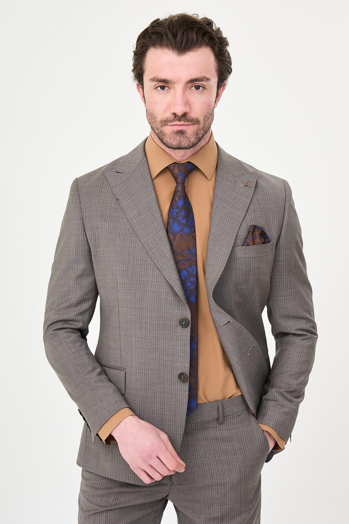 man in a Brown Slim Fit Wide Collar Premium Wool Suit, highlighting the slim-fit trousers and polished dress shoes.