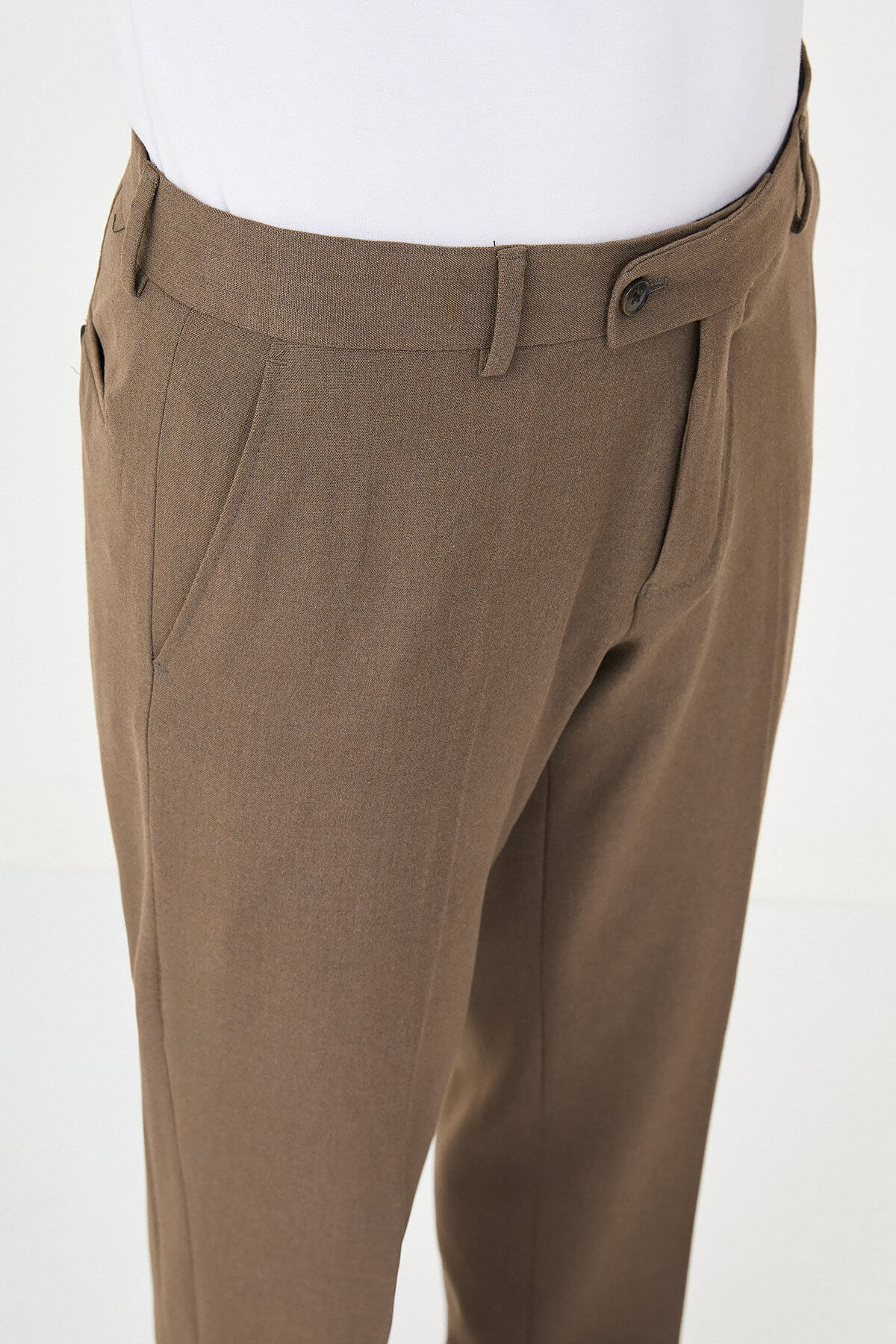 Brown slim-fit formal trousers with front pleats, styled with brown leather shoes, perfect for summer business and semi-formal occasions.