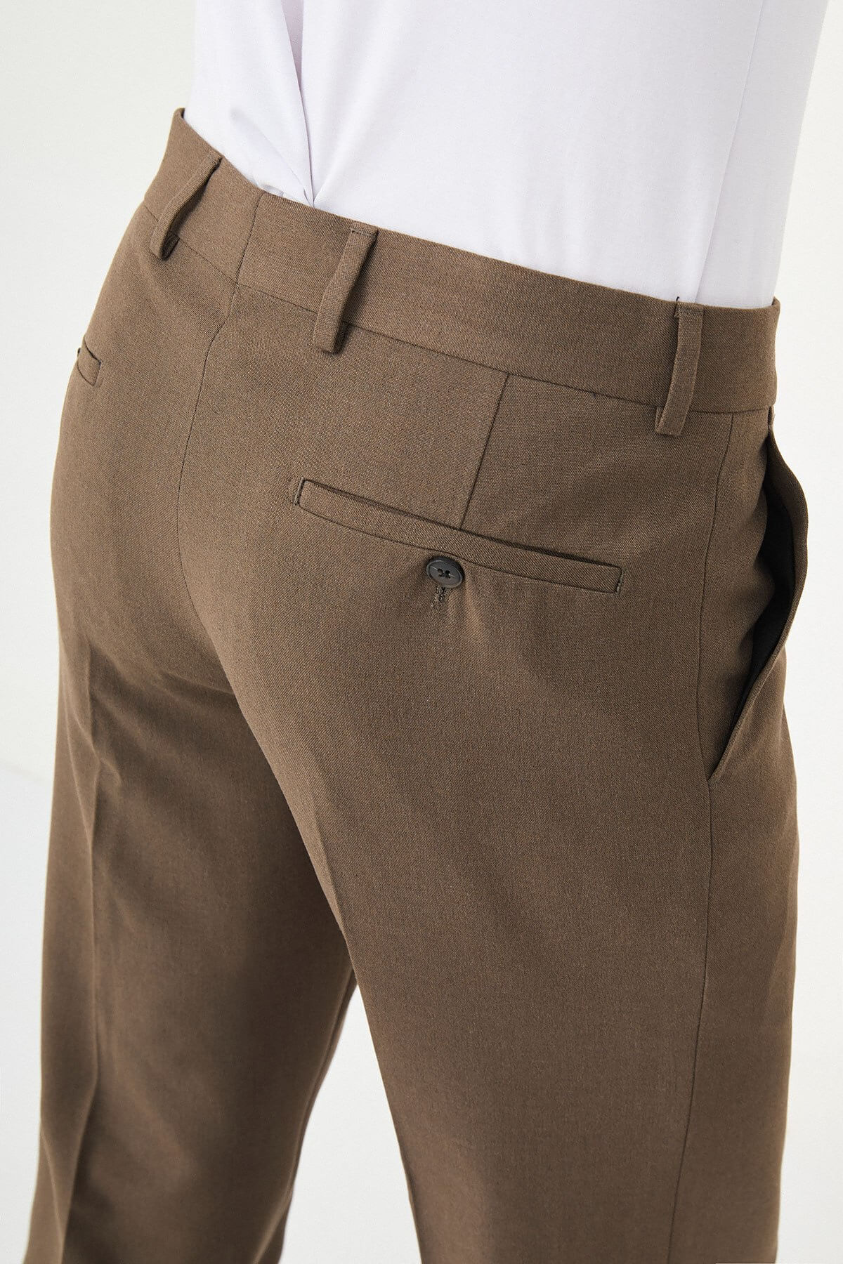 Brown slim-fit formal trousers with front pleats, styled with brown leather shoes, perfect for summer business and semi-formal occasions.