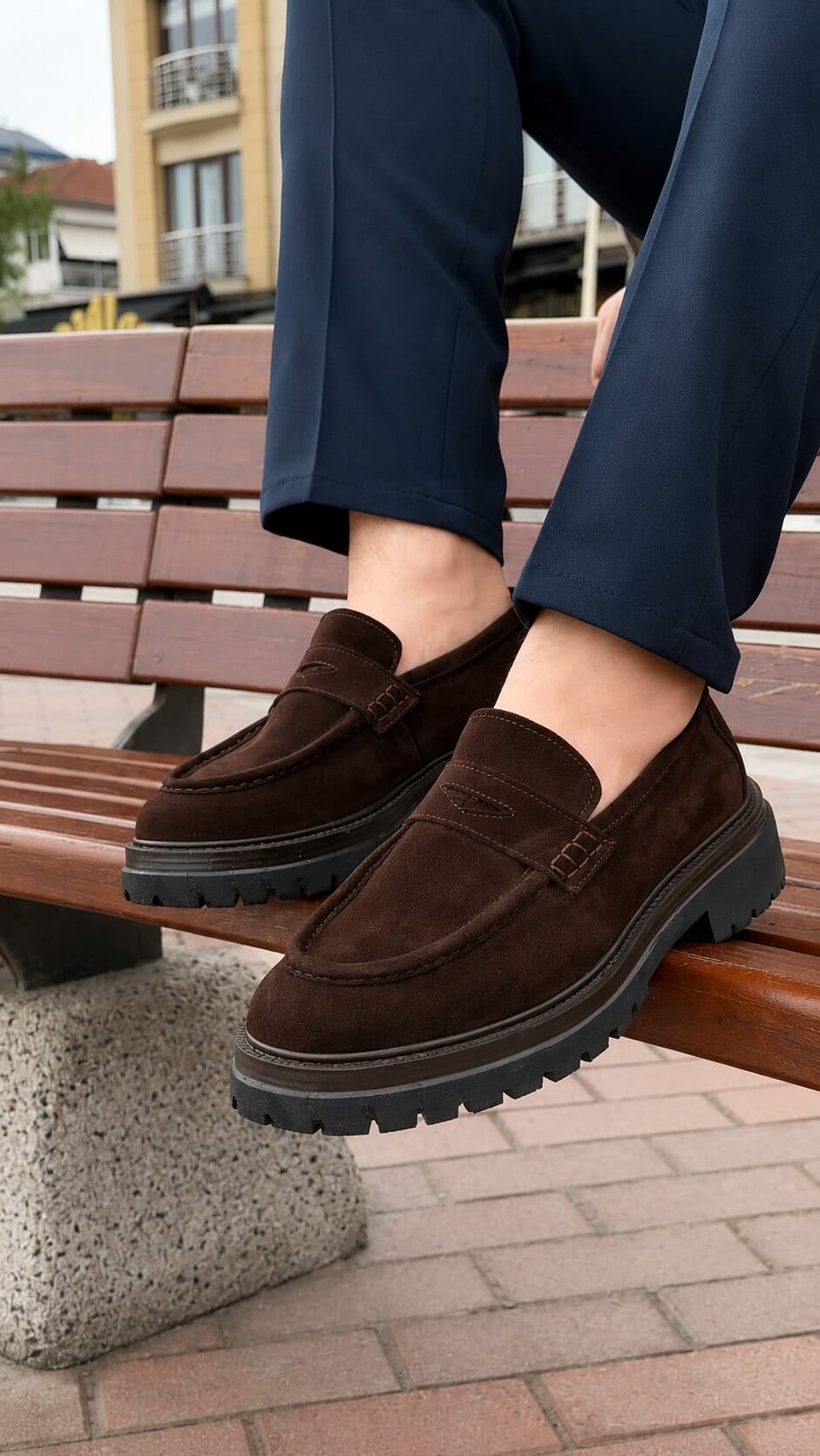 Pair of men's brown suede penny loafers, full view