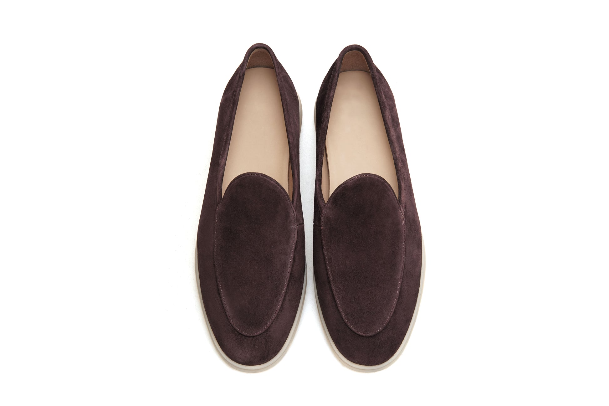 Men’s brown suede slip-on loafers with minimalist apron design and cream sole, perfect for smart-casual summer outfits.