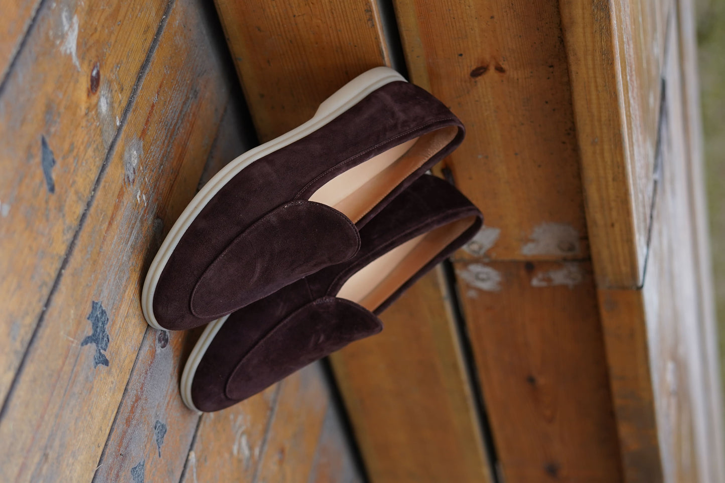 Men’s brown suede slip-on loafers with minimalist apron design and cream sole, perfect for smart-casual summer outfits.