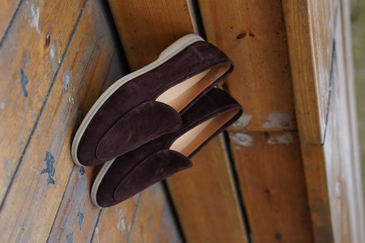 Men’s brown suede slip-on loafers with minimalist apron design and cream sole, perfect for smart-casual summer outfits.