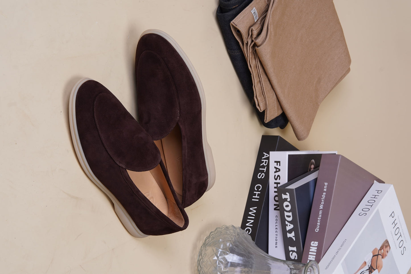 Men’s brown suede slip-on loafers with minimalist apron design and cream sole, perfect for smart-casual summer outfits.