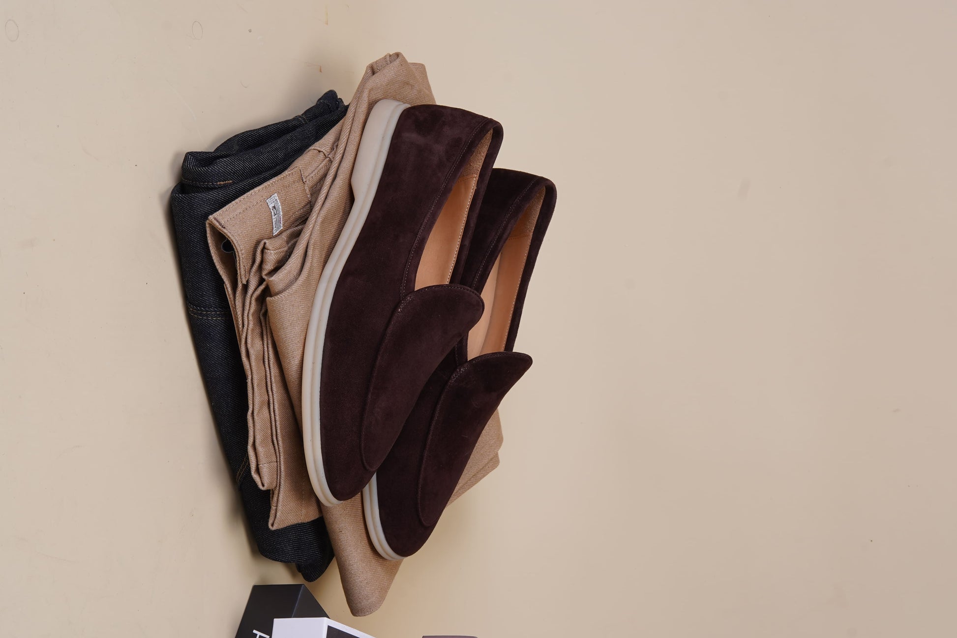 Men’s brown suede slip-on loafers with minimalist apron design and cream sole, perfect for smart-casual summer outfits.