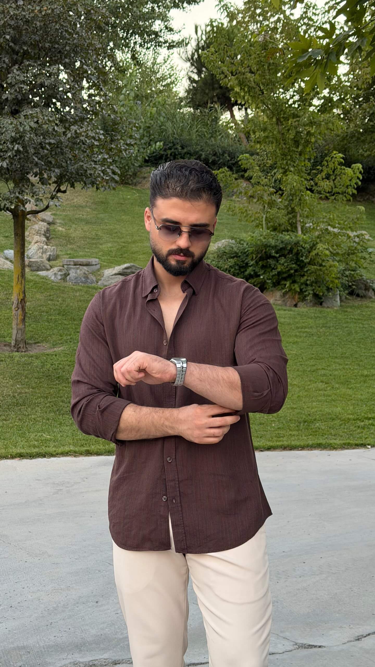 Men’s brown textured cotton long sleeve casual shirt styled with cream trousers and loafers