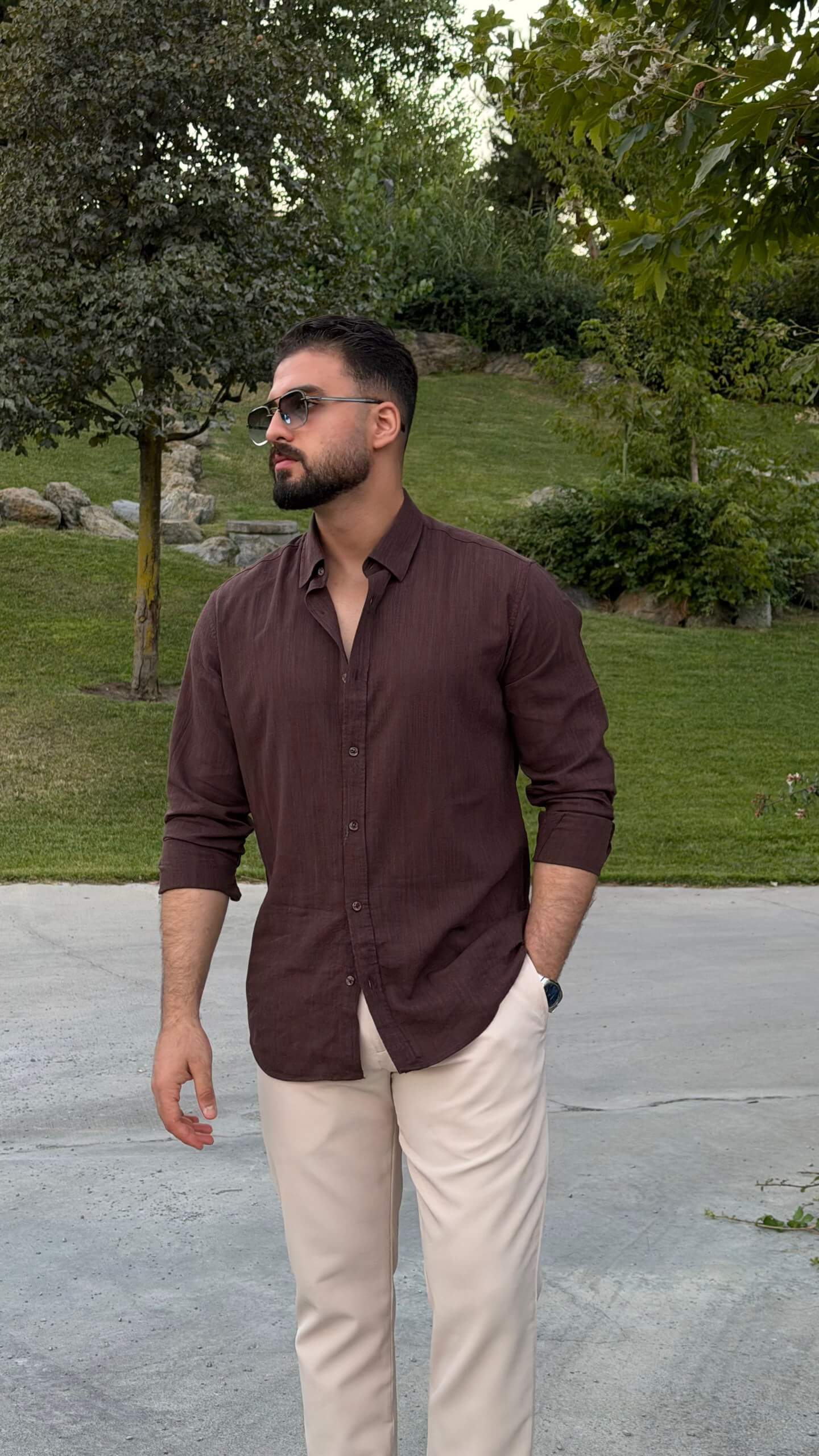 Men’s brown textured cotton long sleeve casual shirt styled with cream trousers and loafers