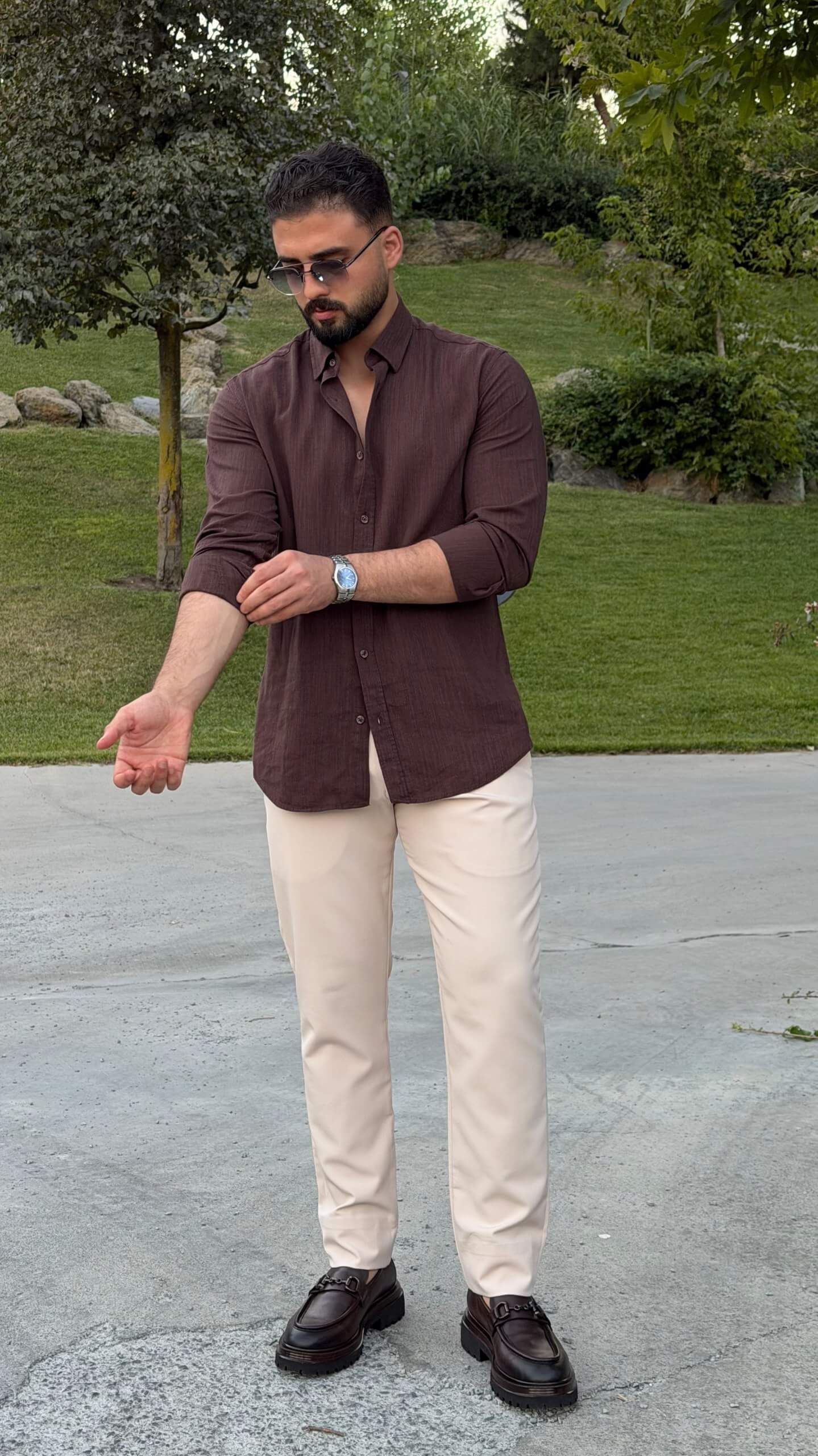 Men’s brown textured cotton long sleeve casual shirt styled with cream trousers and loafers