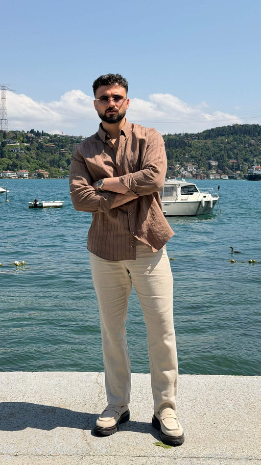 Brown striped men's shirt styled for a summer smart casual outfit, back view
