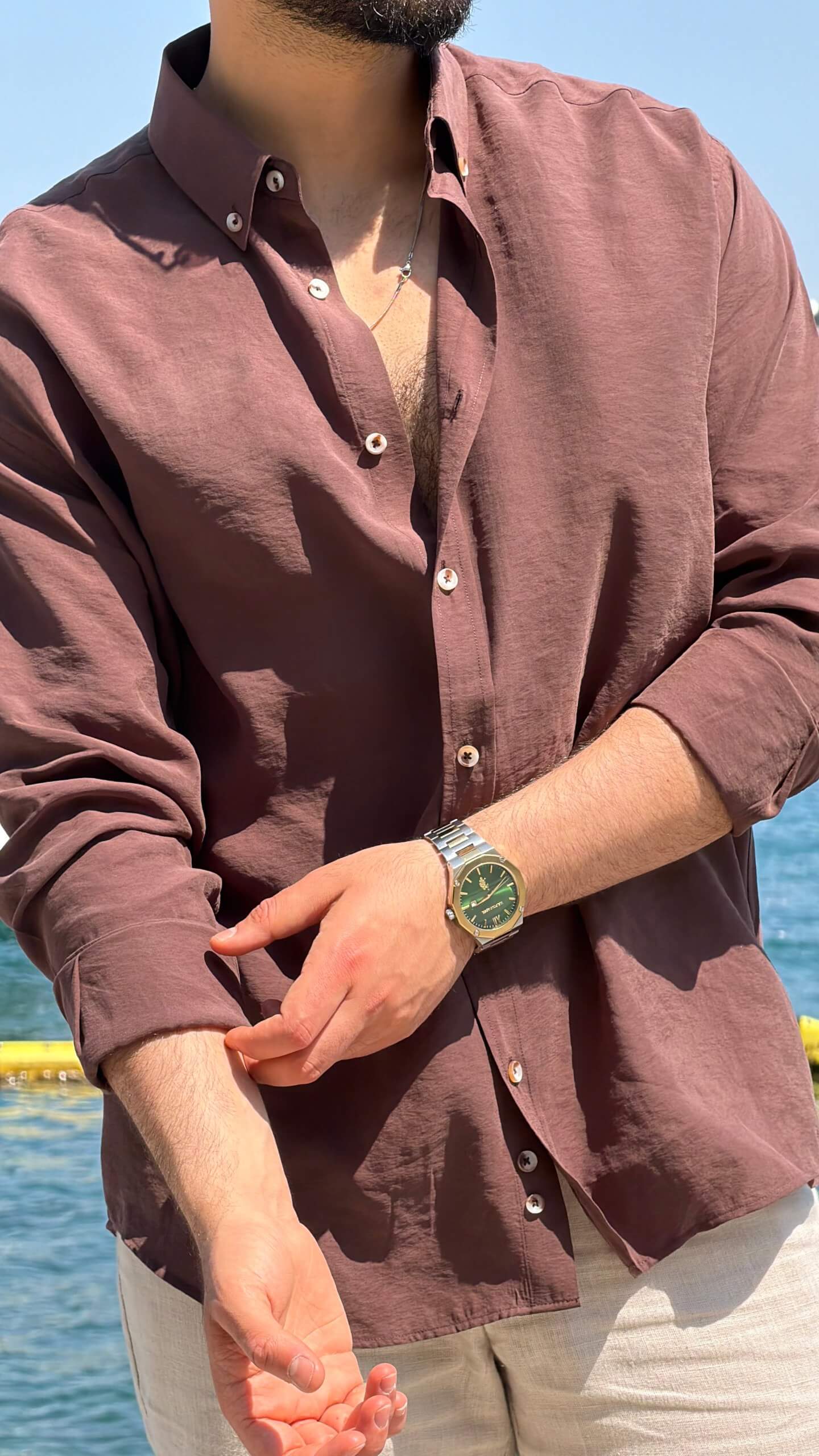 Brown vertical-striped modal-blend shirt showing smooth drape, side view