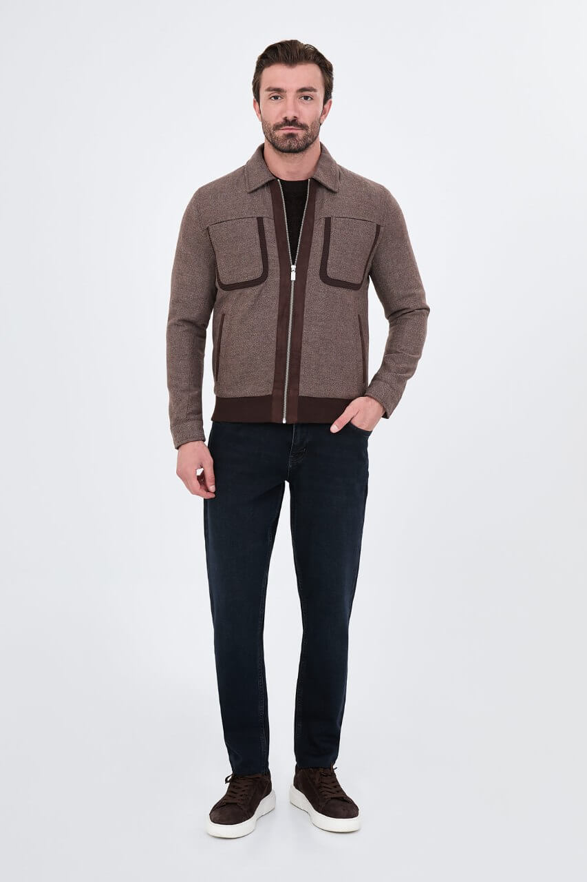 Brown men's casual jacket styled with a black sweater and dark jeans.