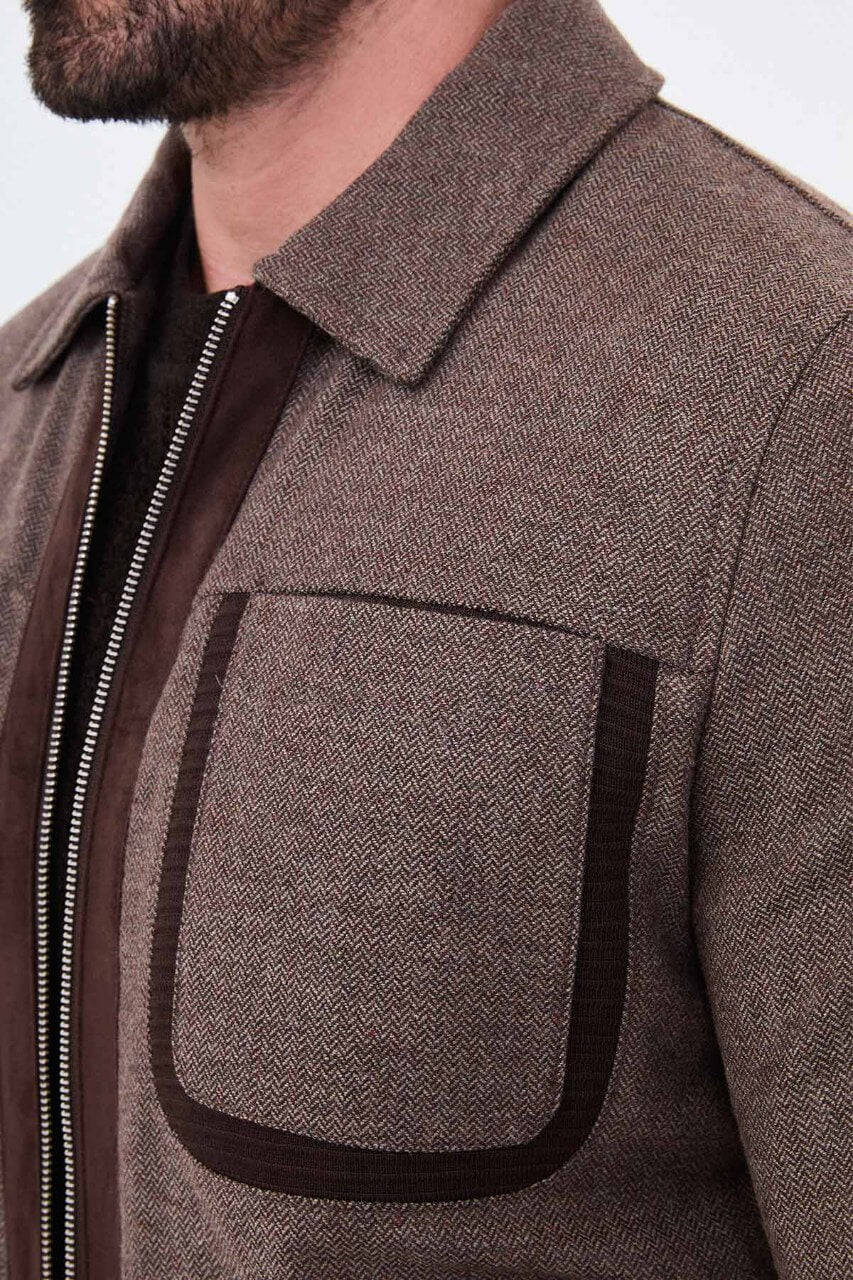 Brown men's casual jacket styled with a black sweater and dark jeans.